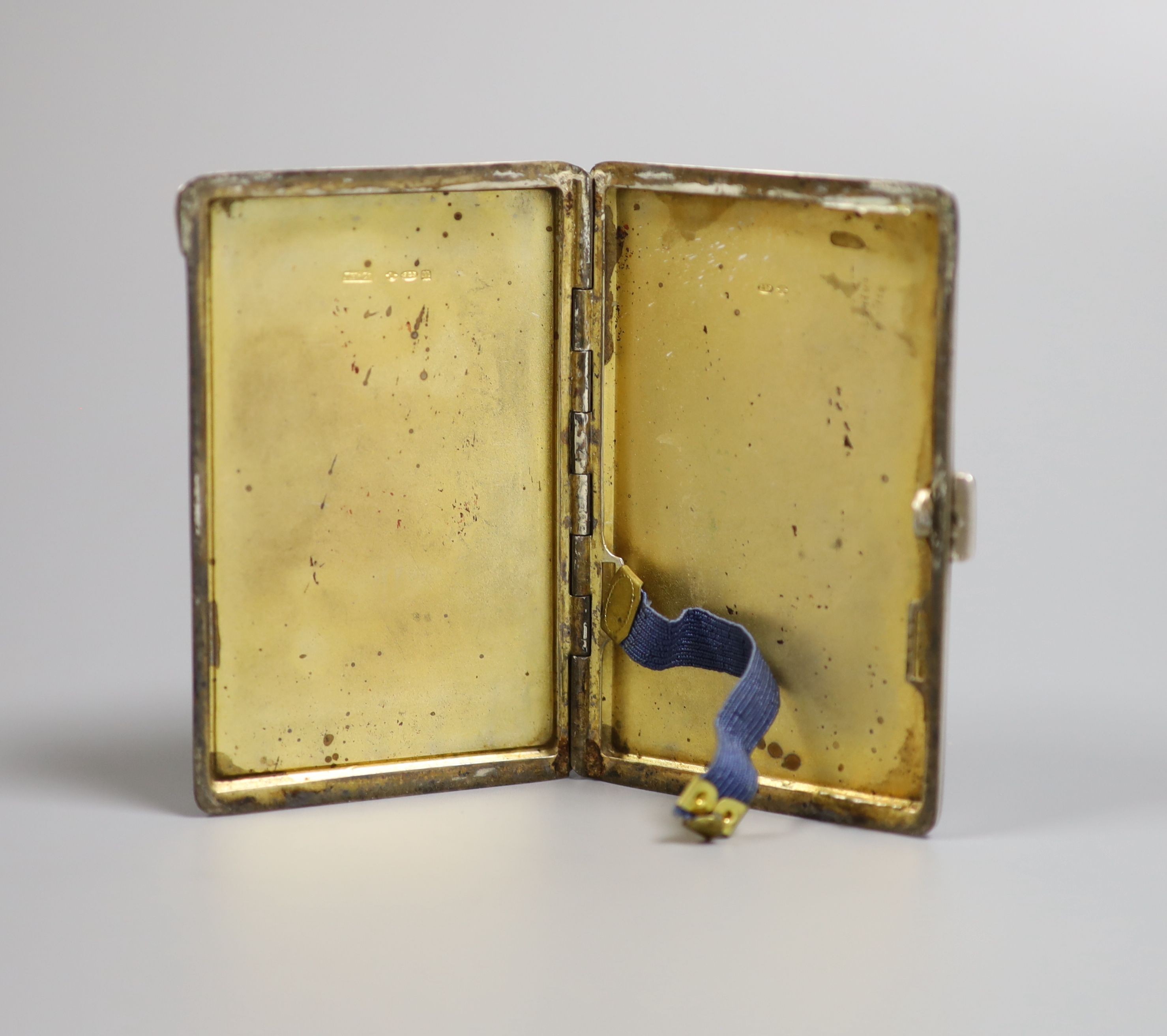 A George V silver and enamel cigarette case, the enamel decorated with a dog, import marks for London, 1928, 87mm.